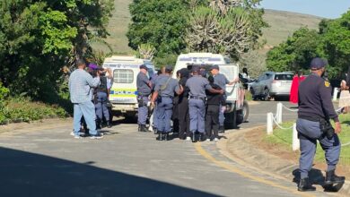 Police officers detain protesters near SAPS vehicles outside the 1820 Settlers National Monument in Makhanda on Friday, 2 October 2026, during demonstrations linked to Rhodes University's proposed 2027 student fee-payment protocol. Photograph: Supplied
